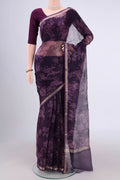 Purple Kota Silk Saree with Floral Print on the body and Zari Border.  displayed on a mannequin