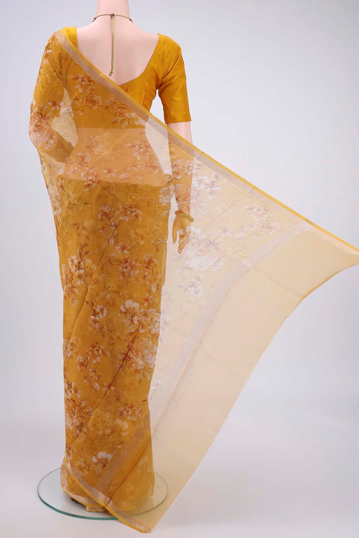 Flat view of Mustard Kota Silk Saree with Printed design on the body and Zari Border. 