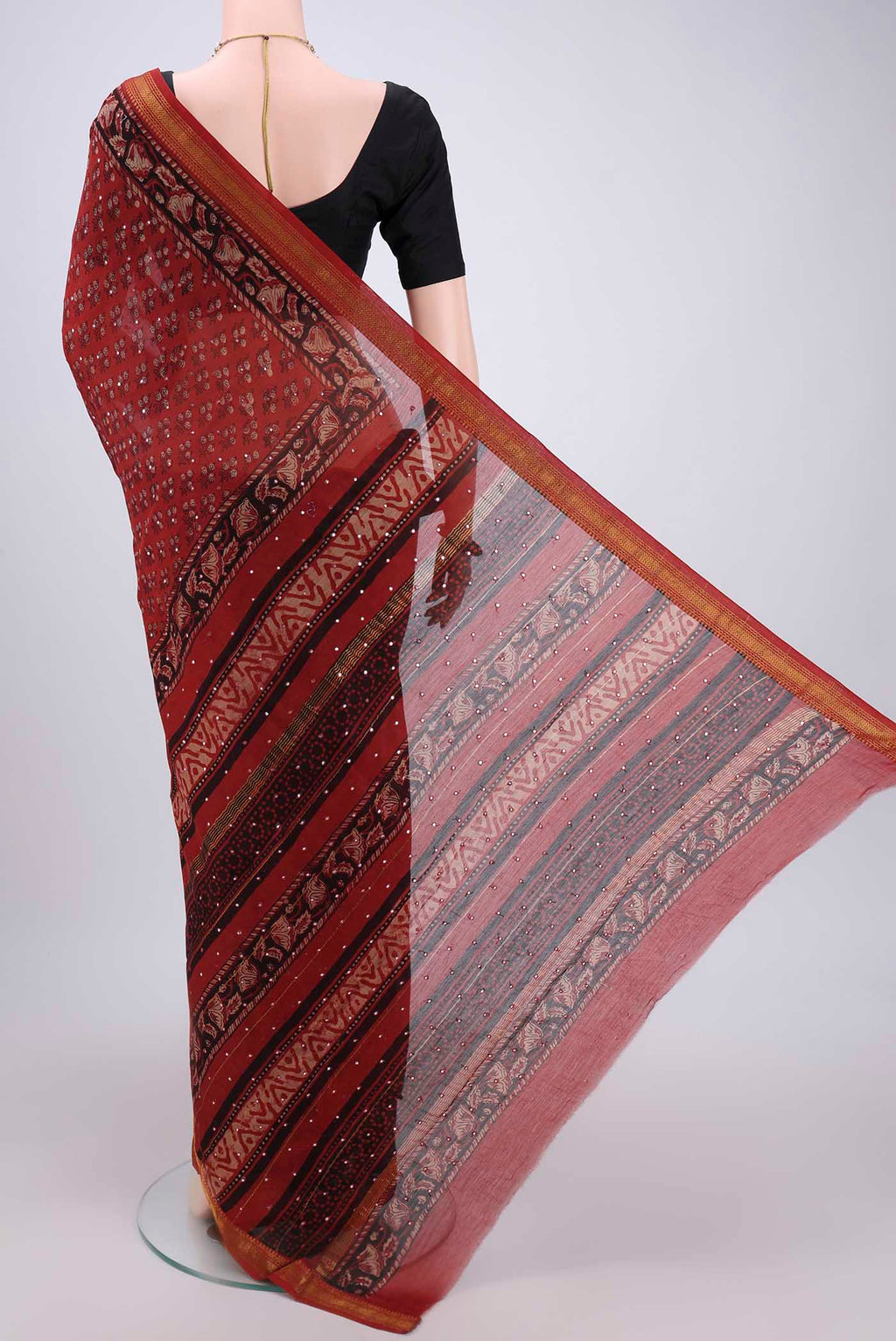 Flat view of Rust Maheshwari Silk Cotton Saree with Printed design on the body and Zari Border. 