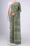 Sea Green Maheshwari Silk Cotton Saree with Batik Print on the body and Zari Border.  displayed on a mannequin