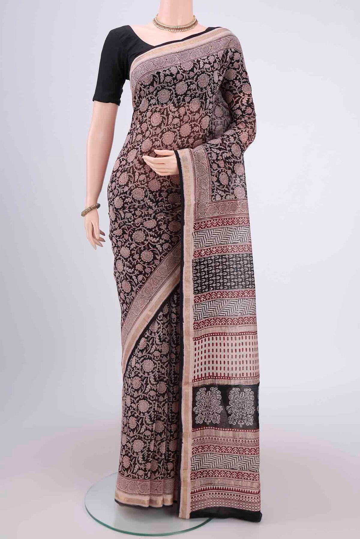 Black Maheshwari Silk Cotton Saree with Printed design on the body and Zari Border.  displayed on a mannequin