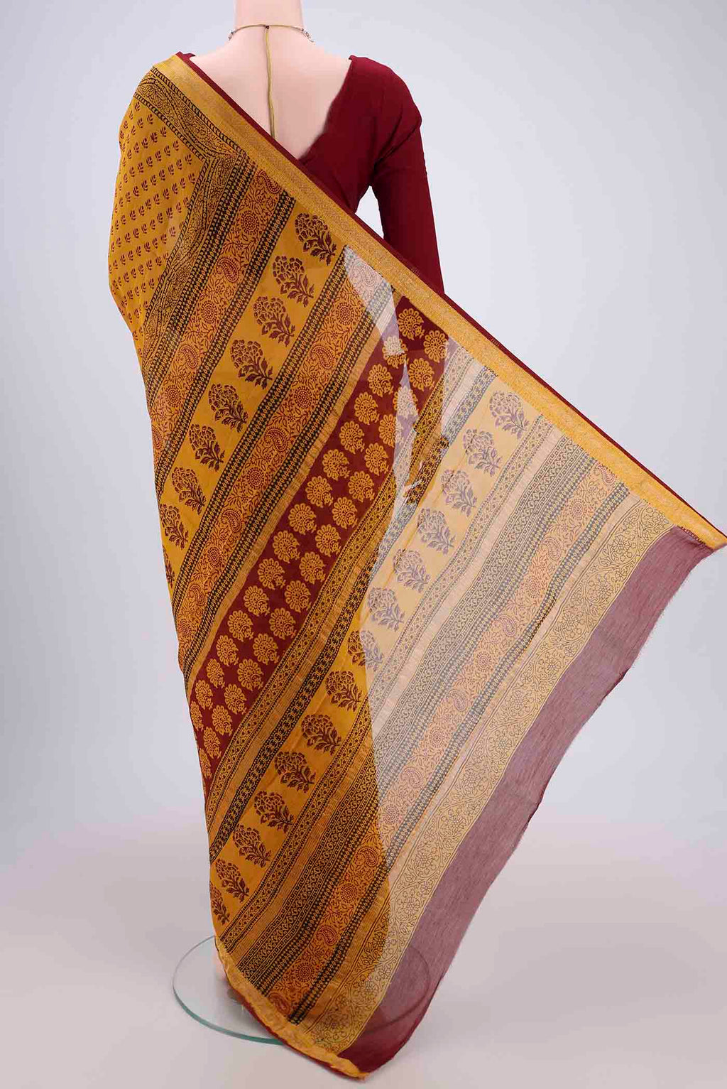 Flat view of Mustard Maheshwari Silk Cotton Saree with Printed design on the body and Zari Border. 