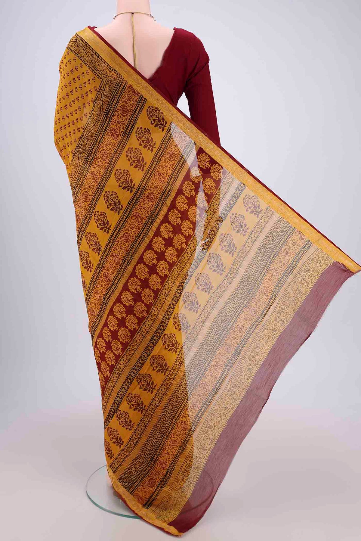 Flat view of Mustard Maheshwari Silk Cotton Saree with Printed design on the body and Zari Border. 