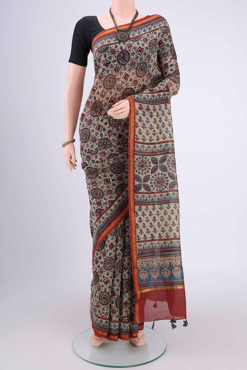 Beige Chanderi Silk Cotton Saree with Ajrakh Print on the body and Zari Border.  displayed on a mannequin