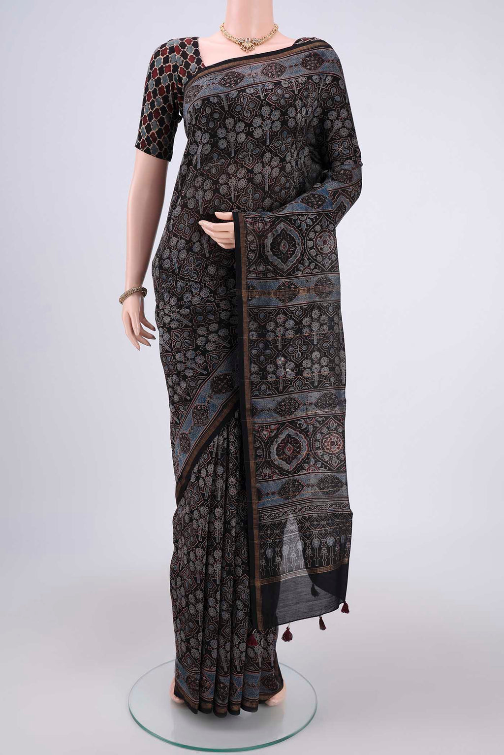 Black Chanderi Silk Cotton Saree with Ajrakh Print on the body and Zari Border.  displayed on a mannequin