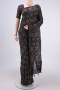 Black Chanderi Silk Cotton Saree with Ajrakh Print on the body and Zari Border.  displayed on a mannequin