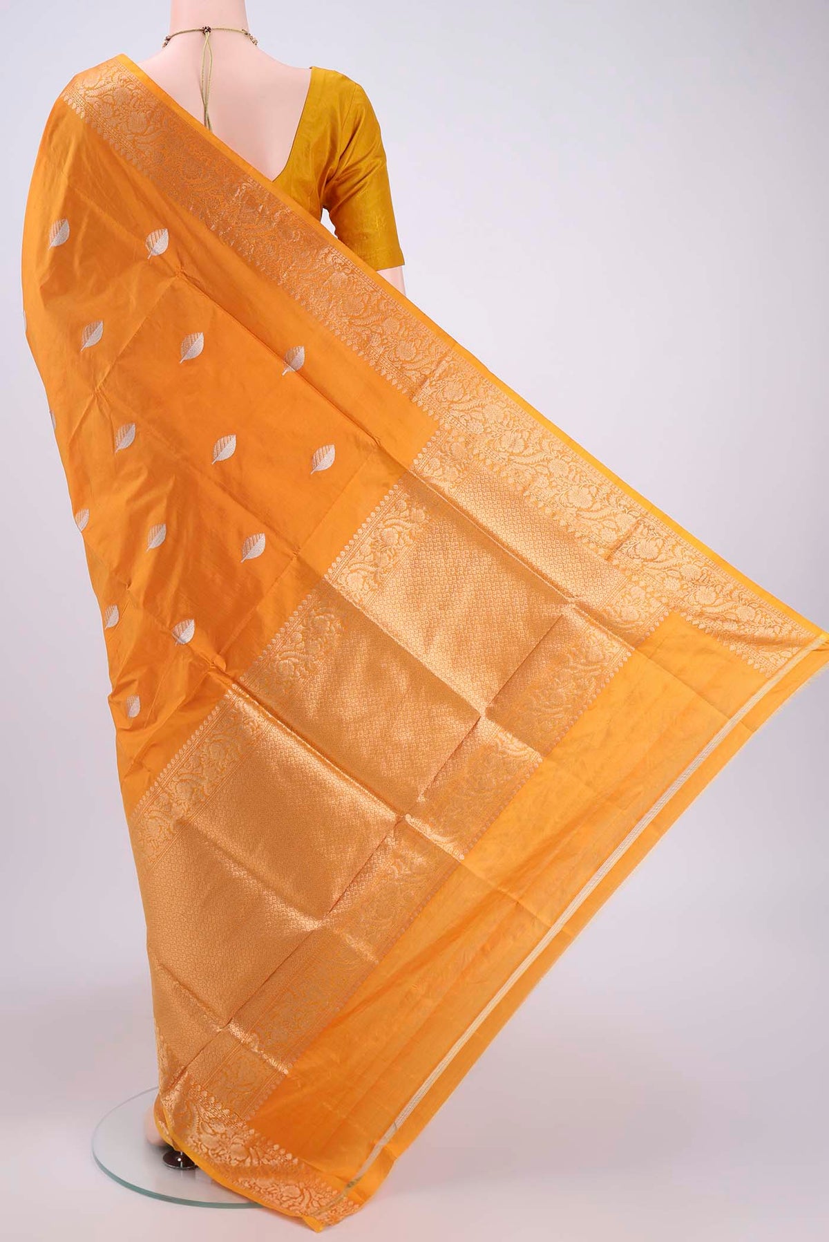 Flat view of Orange Banarasi Katan Silk Saree with Zari Butta on the body and Zari Border. 