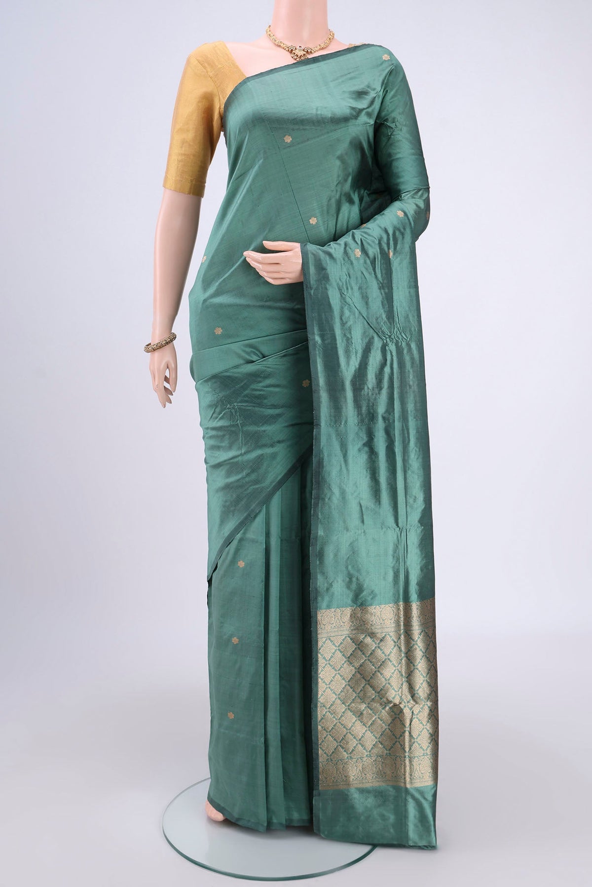 Sage Green Banarasi Katan Silk Saree with Zari Butta on the body and Without Border.  displayed on a mannequin