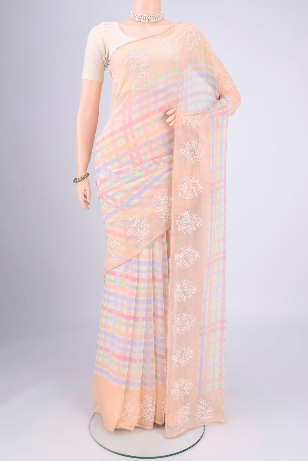 Peach Mysore Chiffon Saree with Checked design on the body and Thread Border.  displayed on a mannequin