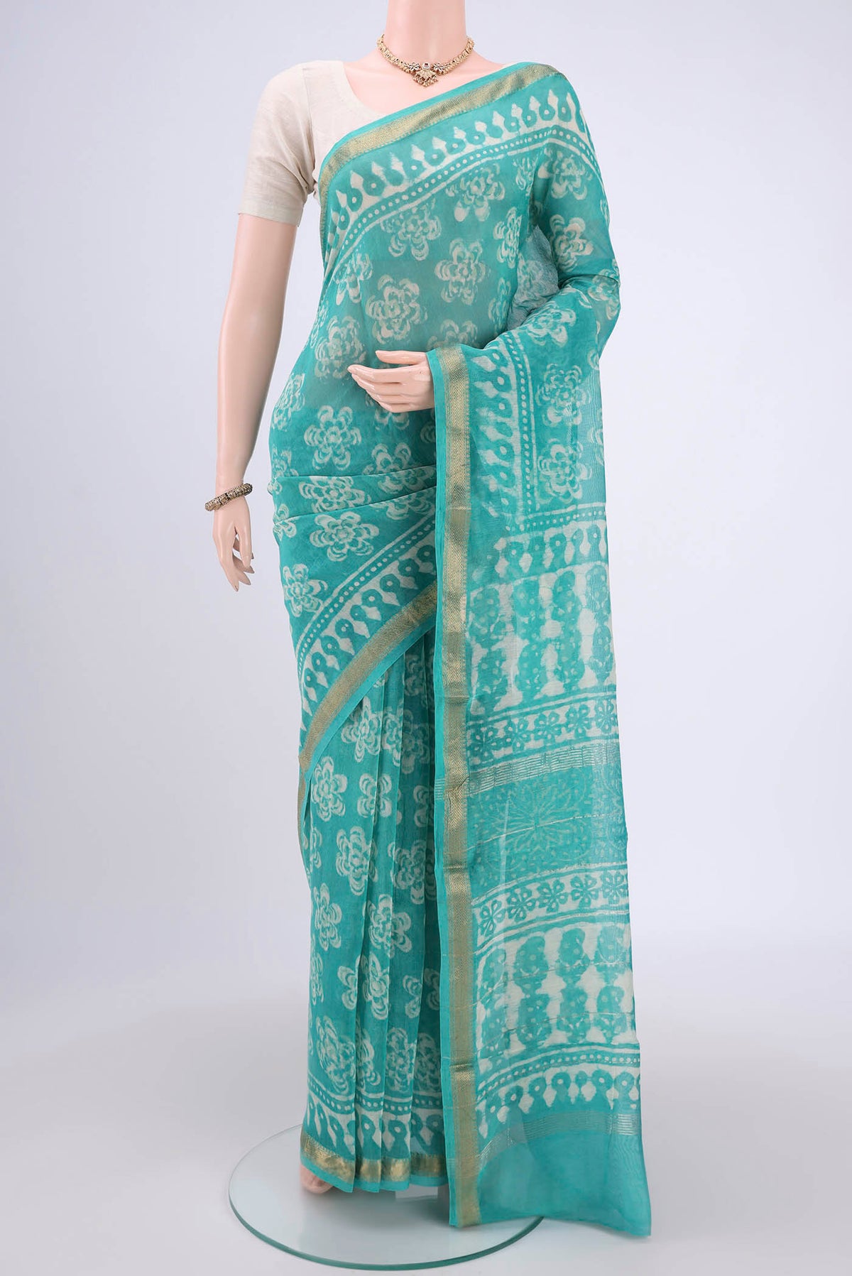 Light Green Maheshwari Silk Cotton Saree with Batik Print on the body and Zari Border.  displayed on a mannequin