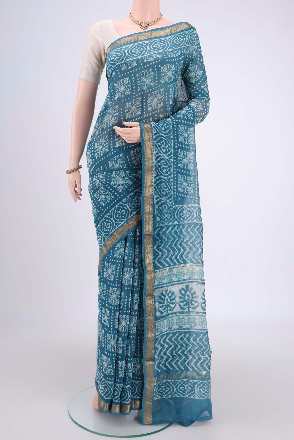 Blue Maheshwari Silk Cotton Saree with Batik Print on the body and Zari Border.  displayed on a mannequin