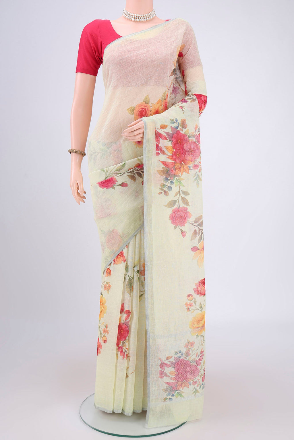 Mint Green Linen Saree with Floral Print on the body and Zari Border.  displayed on a mannequin