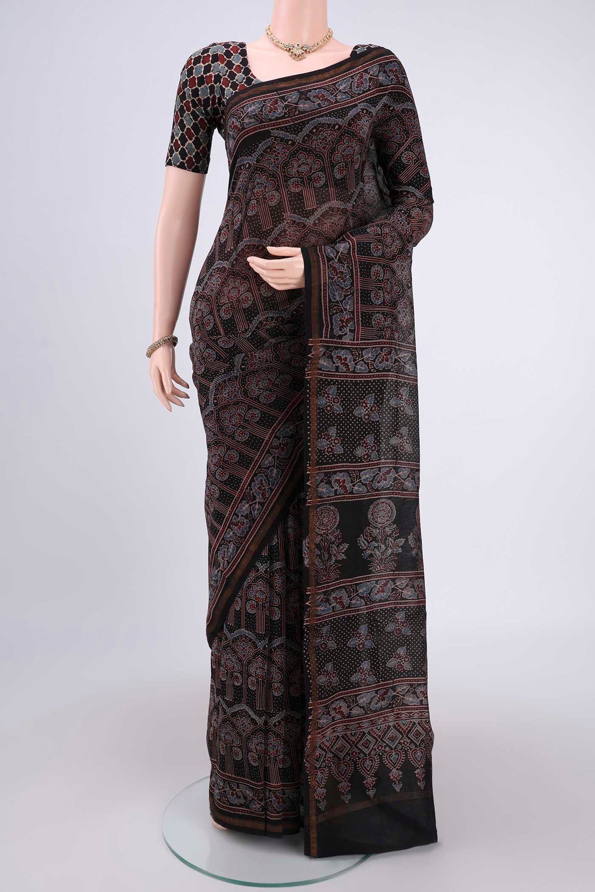 Black Chanderi Silk Cotton Saree with Ajrakh Print on the body and Zari Border.  displayed on a mannequin