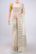 Cream Banarasi Raw Silk Saree with Zari Butta on the body and Zari Border.  displayed on a mannequin