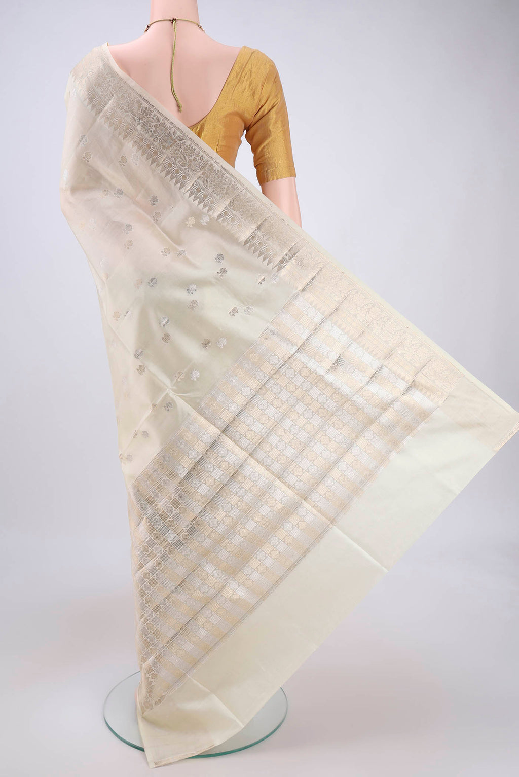 Flat view of Cream Banarasi Raw Silk Saree with Zari Butta on the body and Zari Border. 