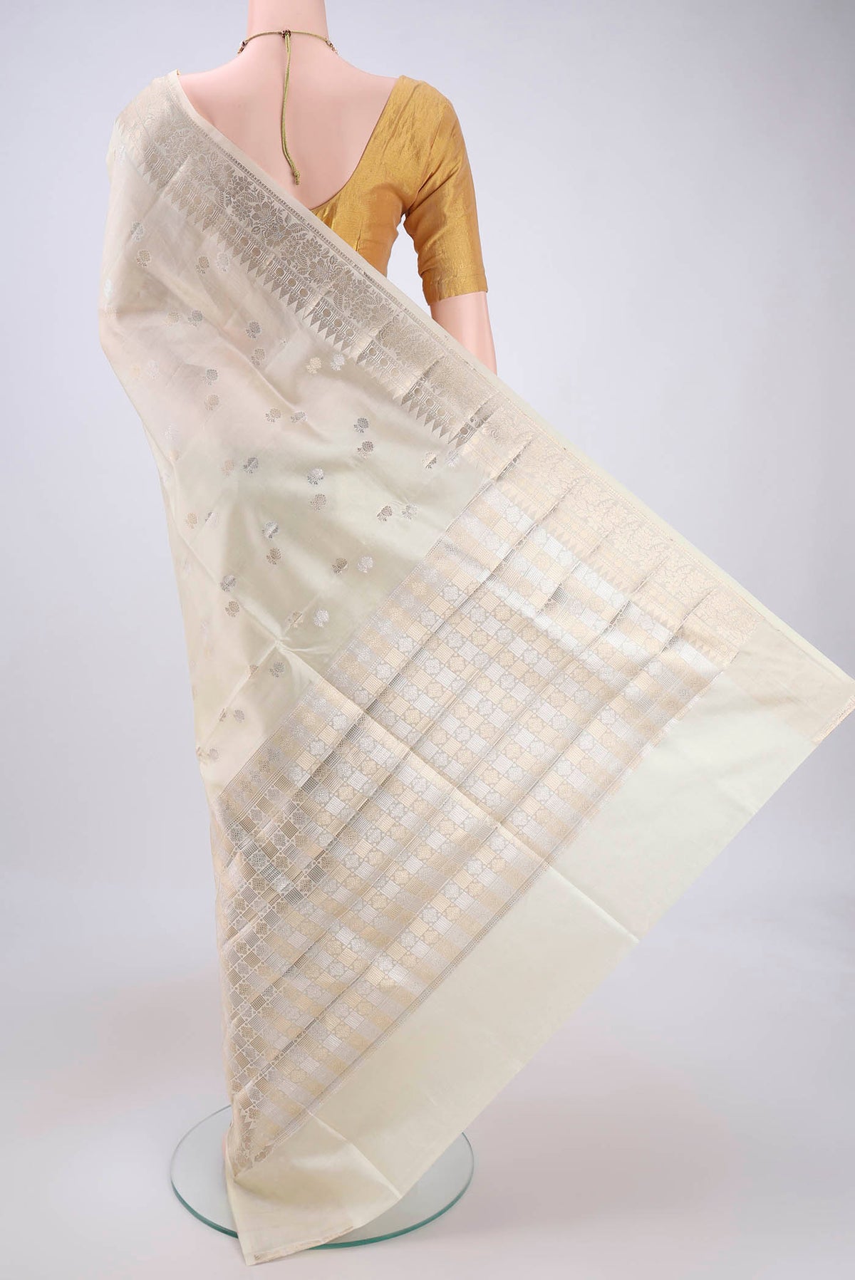 Flat view of Cream Banarasi Raw Silk Saree with Zari Butta on the body and Zari Border. 