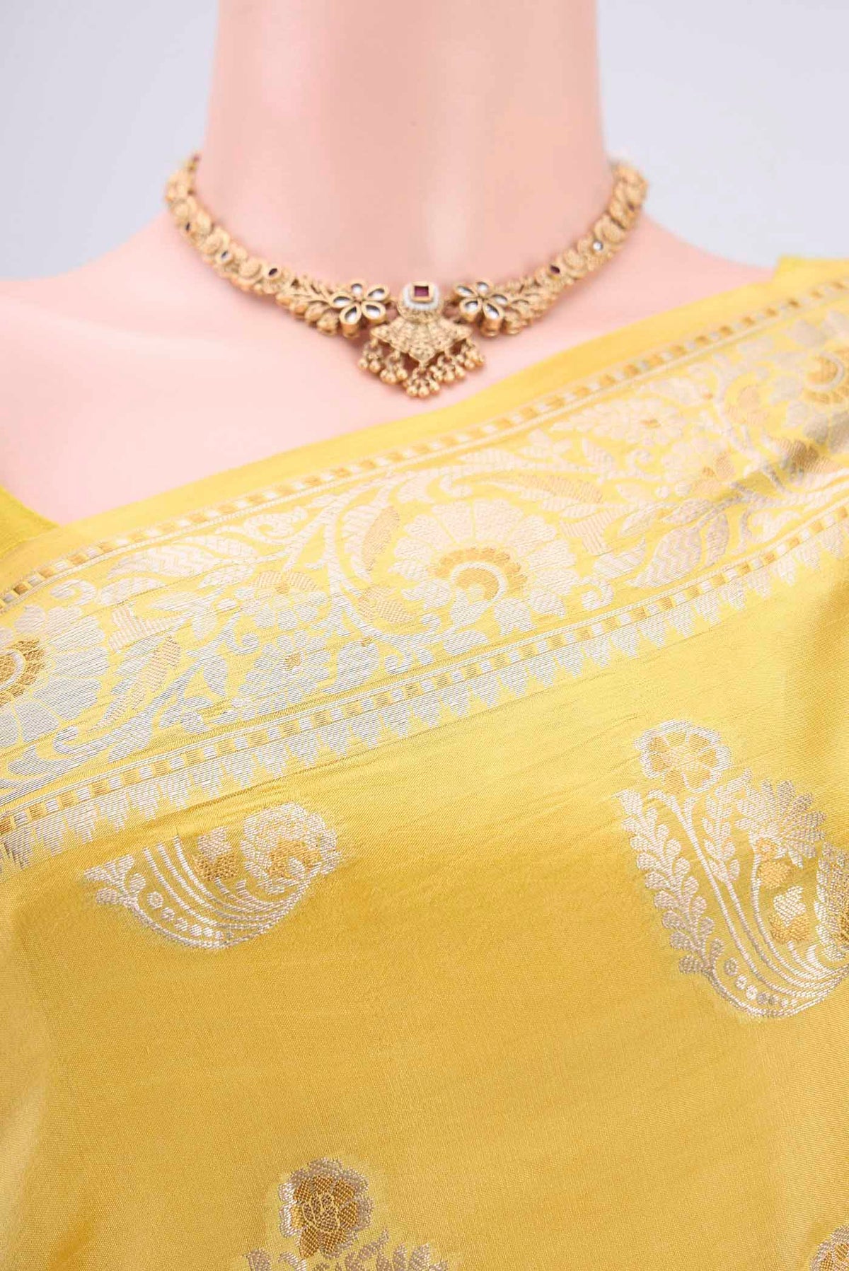 Border image of Yellow Banarasi Raw Silk Saree with Zari Butta on the body and Zari Border. 