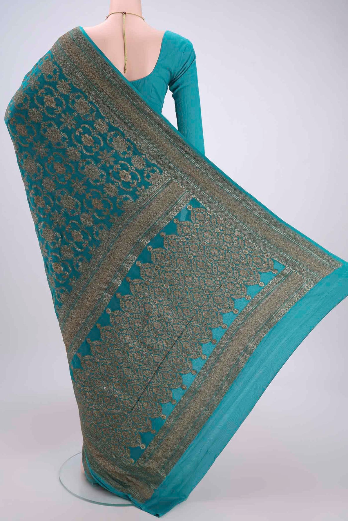 Flat view of Sea Green Banarasi Georgette Saree with Zari Brocade on the body and Zari Border. 