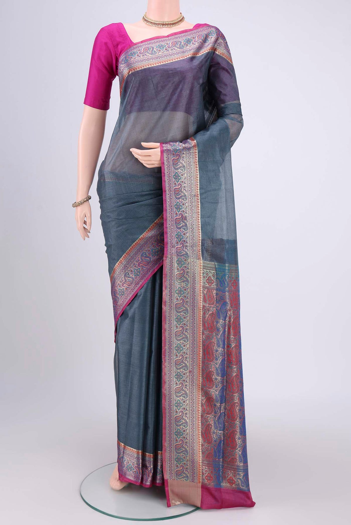 Grey Banarasi Tussar Silk Saree with Zari Butta on the body and Zari And Thread Border.  displayed on a mannequin