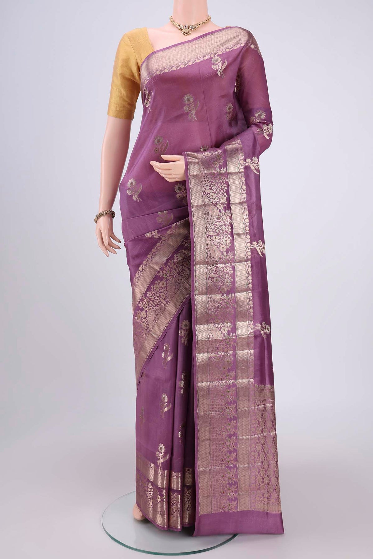 Mauve Banarasi Raw Silk Saree with Zari Butta on the body and Zari Border.  displayed on a mannequin