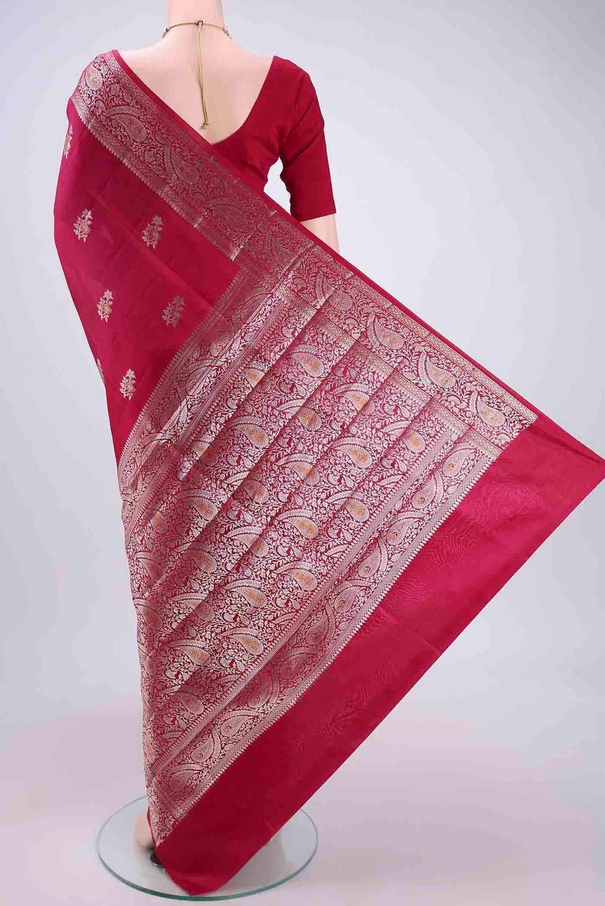 Flat view of Dark Pink Banarasi Raw Silk Saree with Zari Butta on the body and Zari Border. 