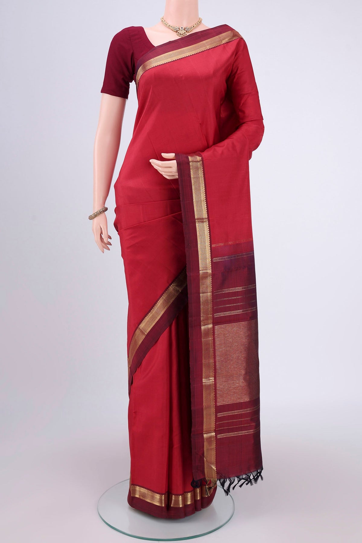 Pure Silk Pure Zari Deep Red Kanjivaram Saree with Zari Butta on the body and Zari Border.  displayed on a mannequin