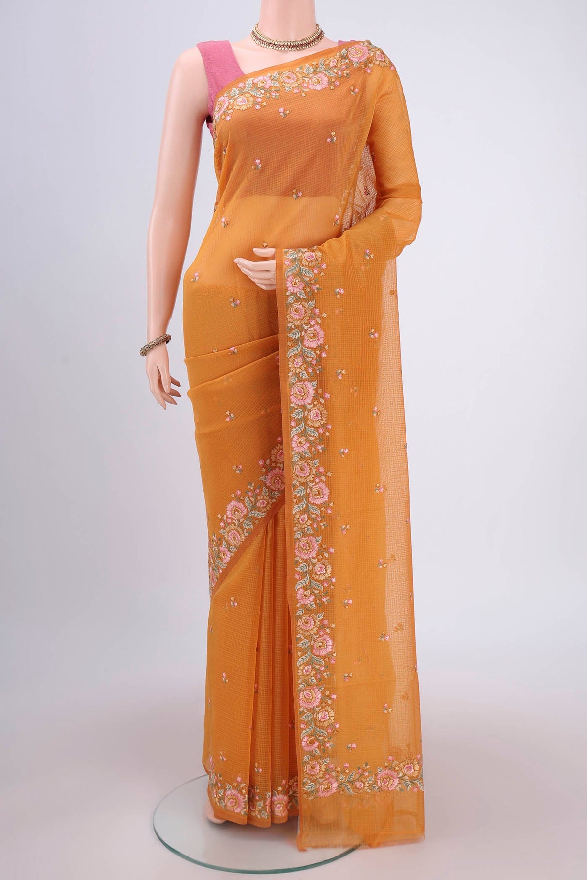 Brick Orange Kota Cotton Saree with Embroidery on the body and Thread Border.  displayed on a mannequin