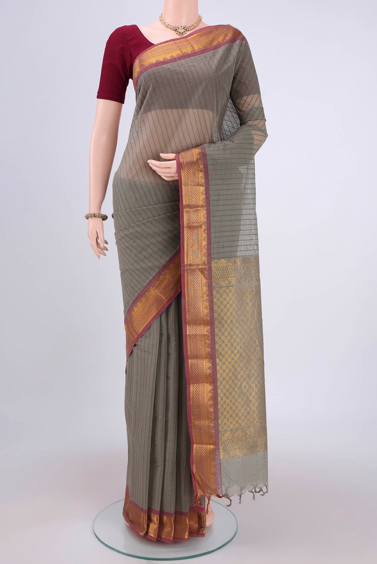 Grey Kanchi Cotton Saree with Stripes on the body and Thread Border.  displayed on a mannequin