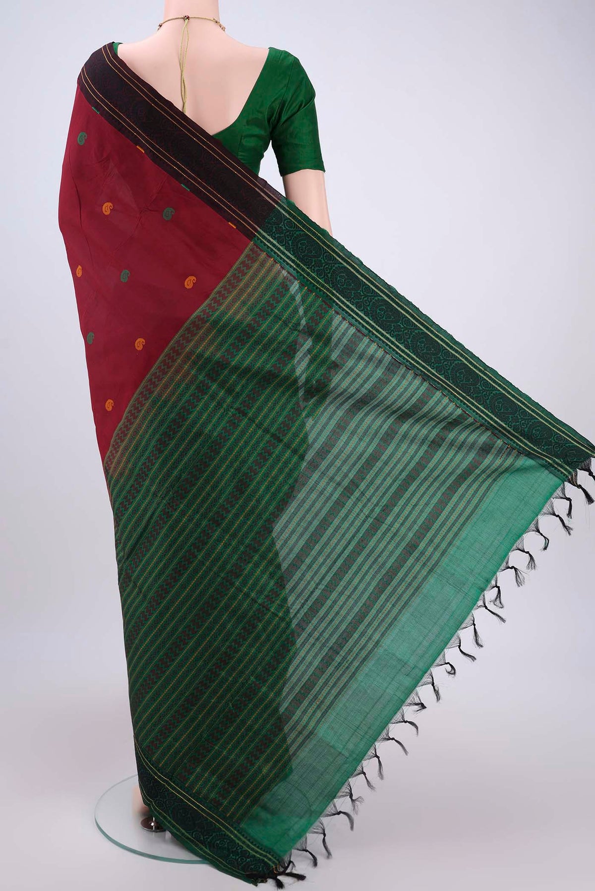 Flat view of Maroon Blended Poly Cotton Saree with Thread Butta on the body and Thread Border. 