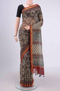 Beige Chanderi Silk Cotton Saree with Ajrakh Print on the body and Zari Border.  displayed on a mannequin