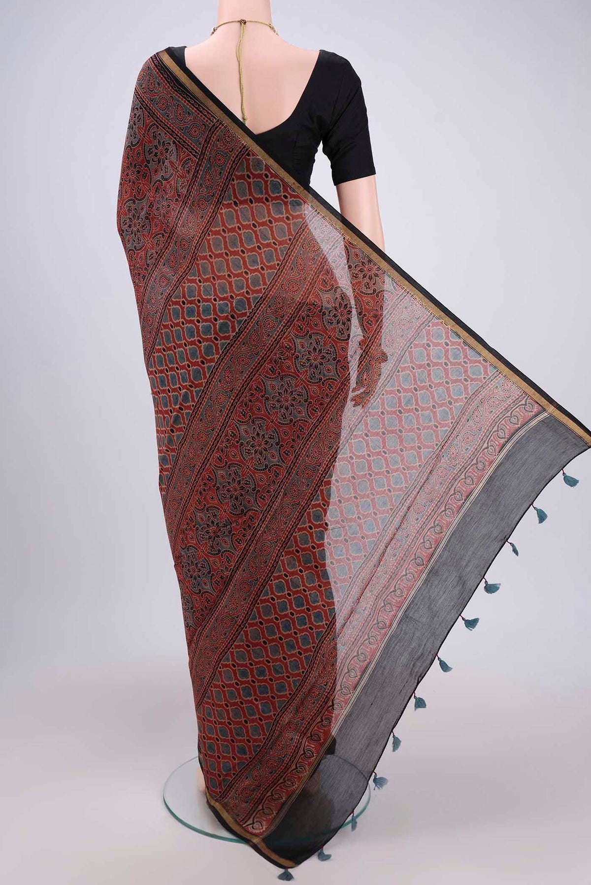 Flat view of Maroon Chanderi Silk Cotton Saree with Ajrakh Print on the body and Zari Border. 