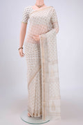 Off White Maheshwari Silk Cotton Saree with Batik Print on the body and Zari Border.  displayed on a mannequin