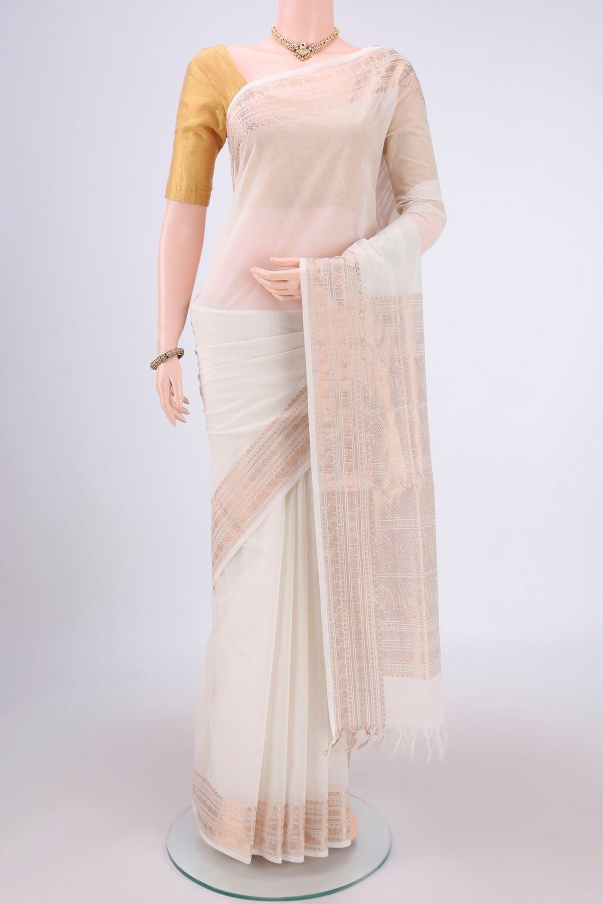 Off White Kanchi Cotton Saree with Plain Body and Zari Border.  displayed on a mannequin