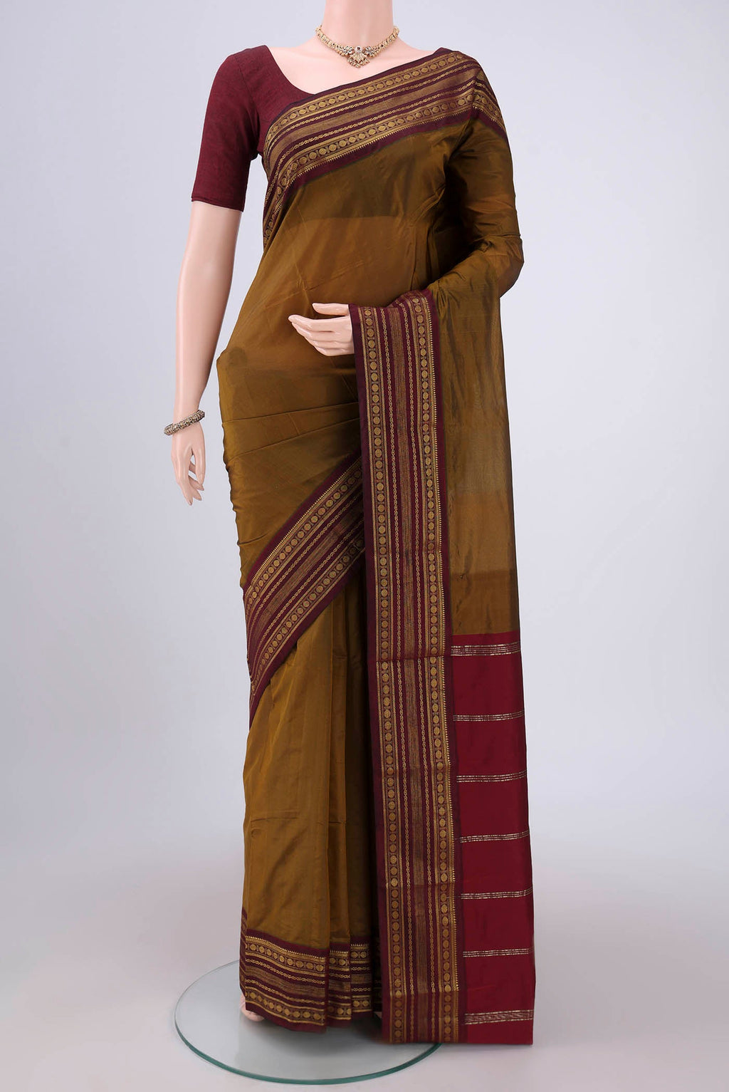 Mehandi Green Blended Bangalore Silk Saree with Plain Body and Zari Border.  displayed on a mannequin