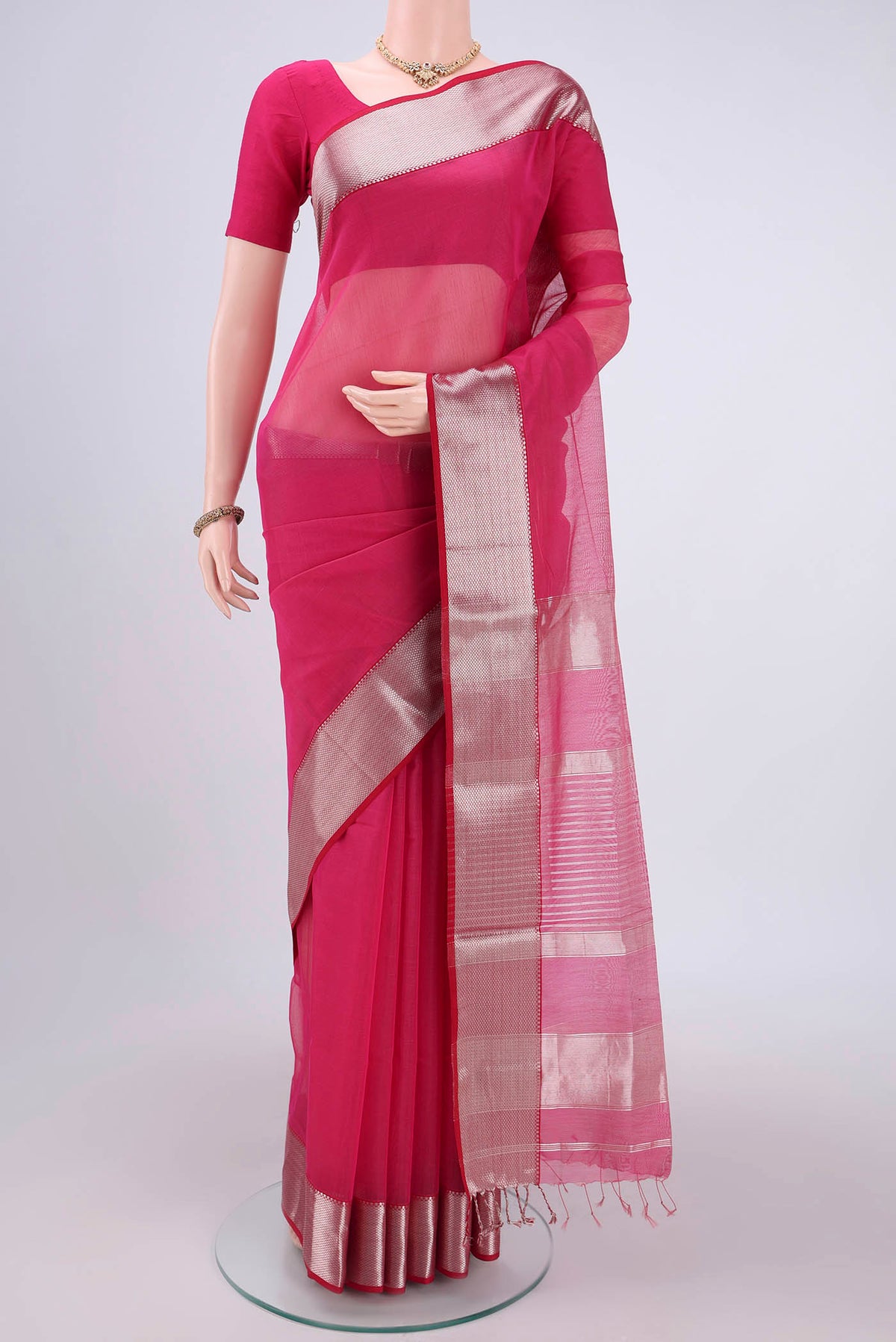 Pink Maheshwari Silk Cotton Saree with Zari And Thread Butta on the body and Zari Border.  displayed on a mannequin