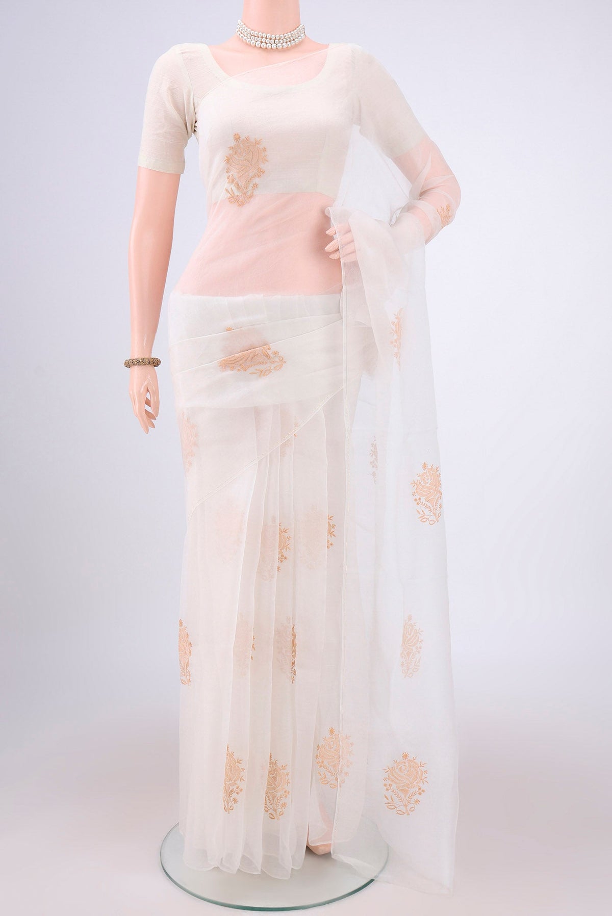 White Organza Silk Saree with Embroidery on the body and Thin Zari Line.  displayed on a mannequin