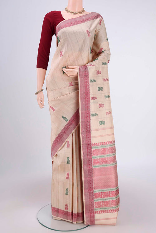 Beige Kanchipuram Saree with Thread Butta on the body and Thread Border.  displayed on a mannequin