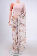 Off White Linen Saree with Floral Print on the body and Zari Border.  displayed on a mannequin