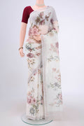 Off White Linen Saree with Floral Print on the body and Zari Border.  displayed on a mannequin
