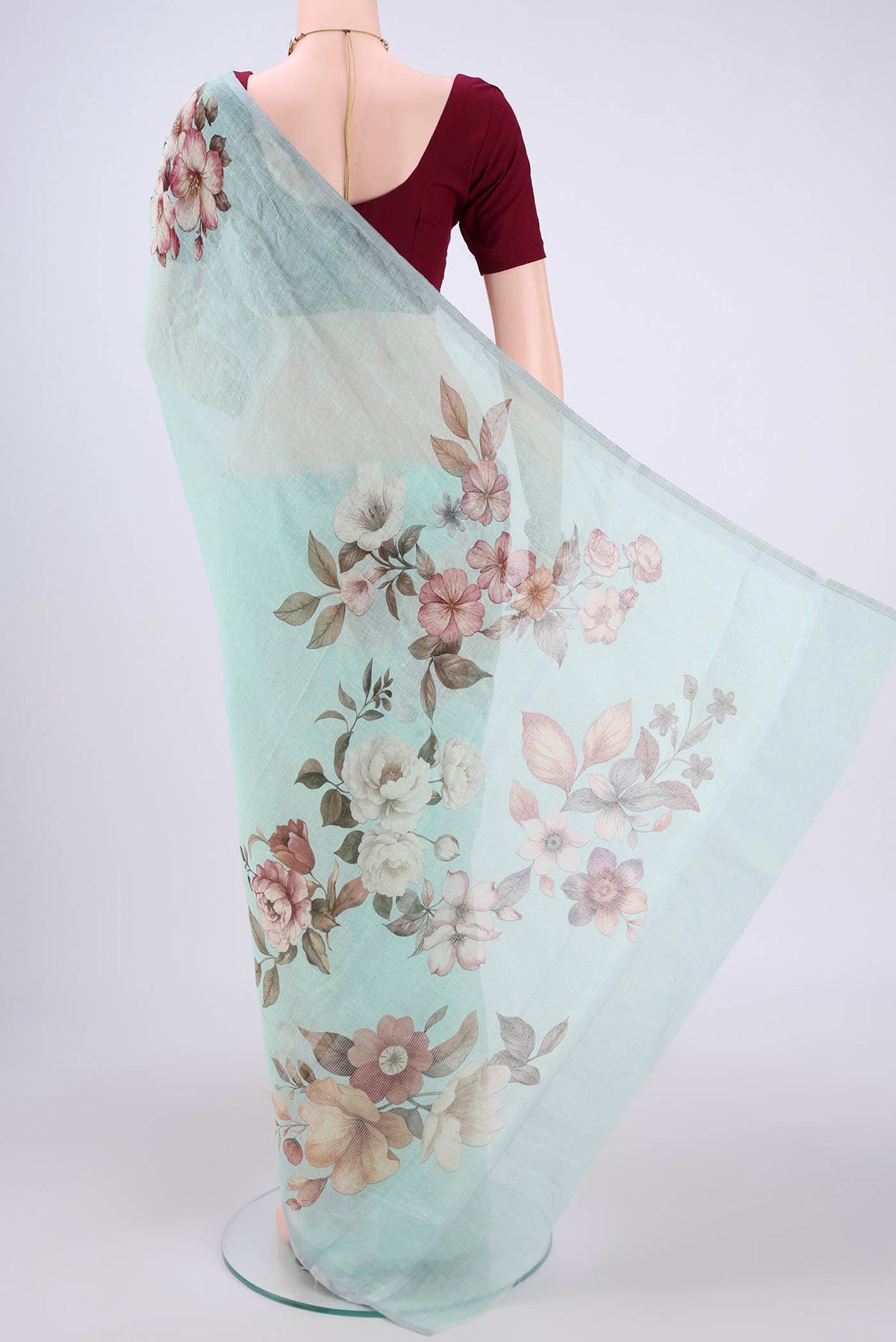 Flat view of Sea Green Linen Saree with Floral Print on the body and Zari Border. 