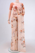 Peach Linen Saree with Floral Print on the body and Zari Border.  displayed on a mannequin