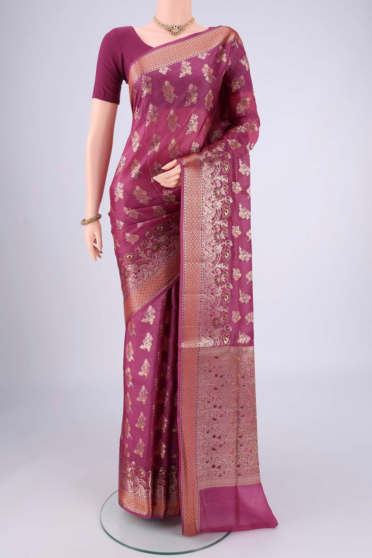 Magenta Banarasi Tussar Silk Saree with Zari And Thread Butta on the body and Zari And Thread Border.  displayed on a mannequin