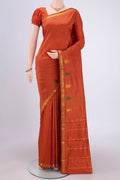 Rust Kanchipuram Silk Saree with Plain Body and Thread Border.  displayed on a mannequin