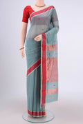 Sage Green Maheshwari Silk Cotton Saree with Zari And Thread Butta on the body and Zari Border.  displayed on a mannequin