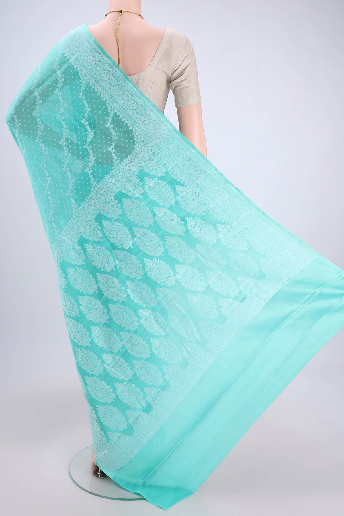 Flat view of Turquoise Blended Banarasi Georgette Saree with Thread Brocade on the body and Zari Border. 