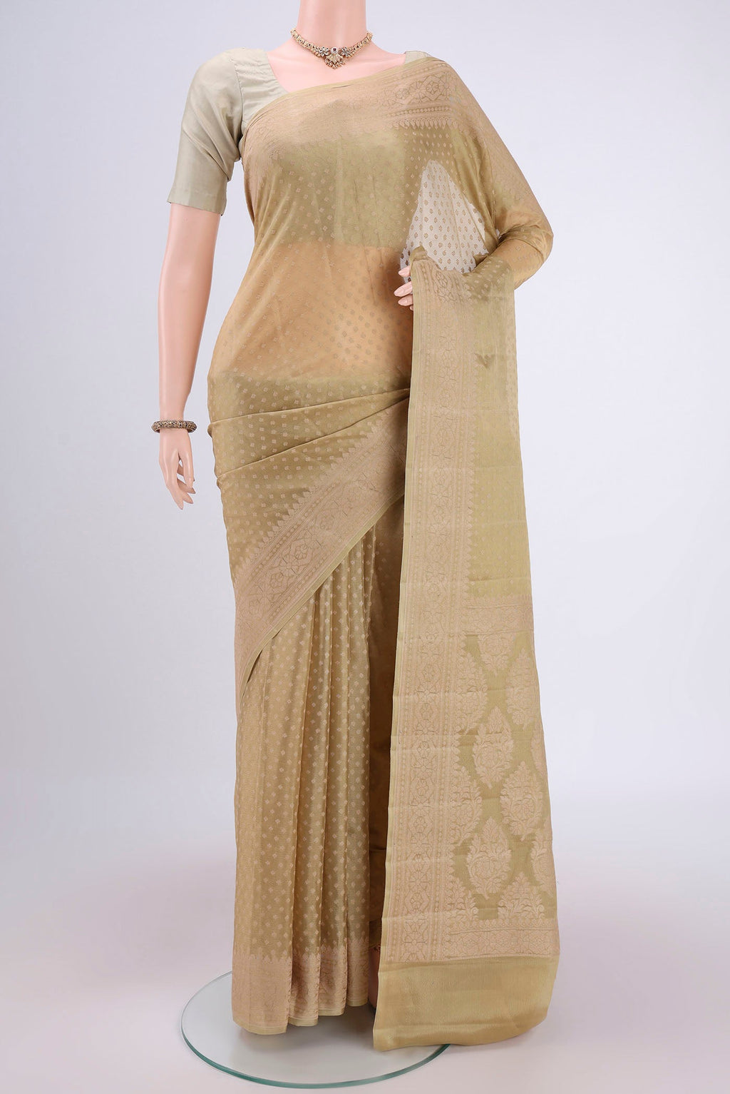 Beige Blended Banarasi Georgette Saree with Thread Butta on the body and Thread Border.  displayed on a mannequin