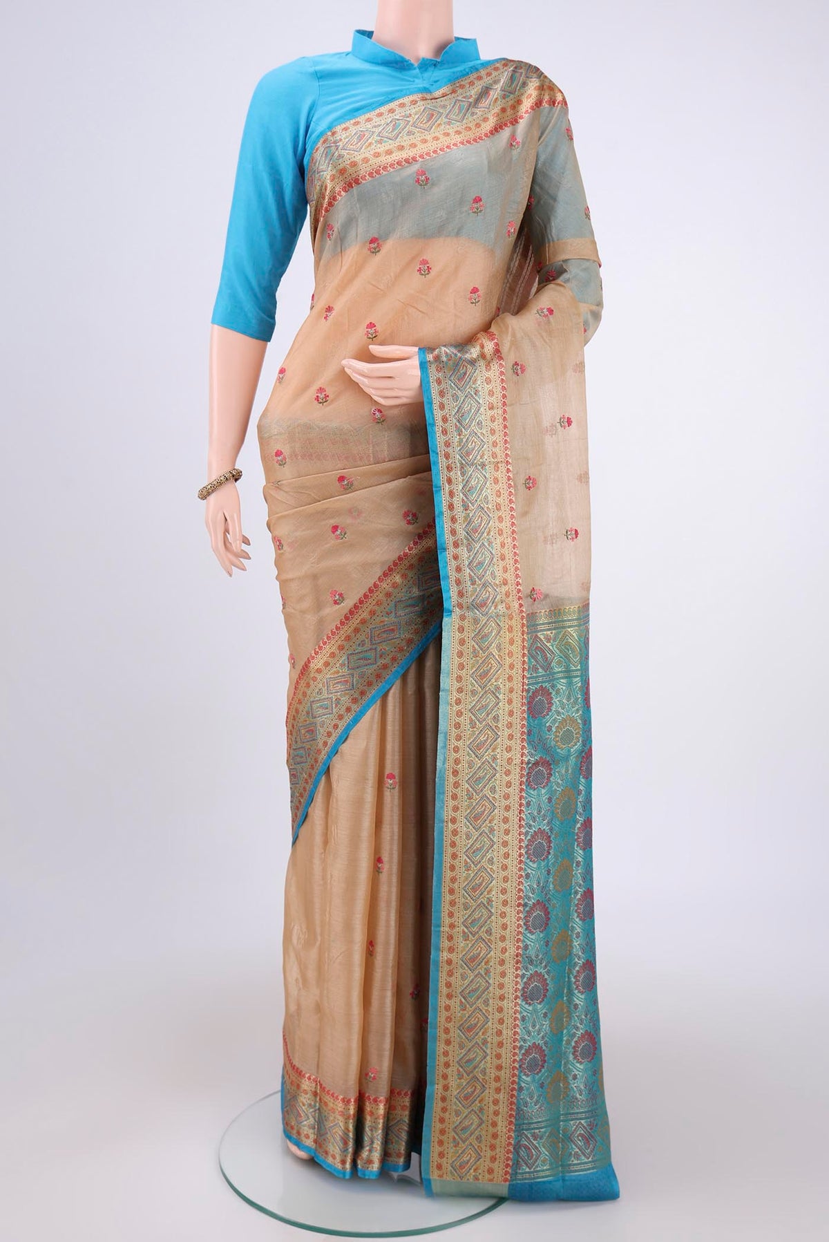 Sea Green Banarasi Tussar Silk Saree with Embroidery on the body and Zari And Thread Border.  displayed on a mannequin