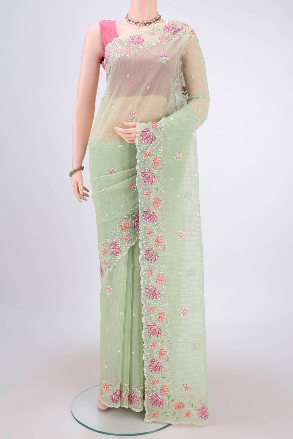 Light Green Kota Cotton Saree with Embroidery on the body and Thread Border.  displayed on a mannequin