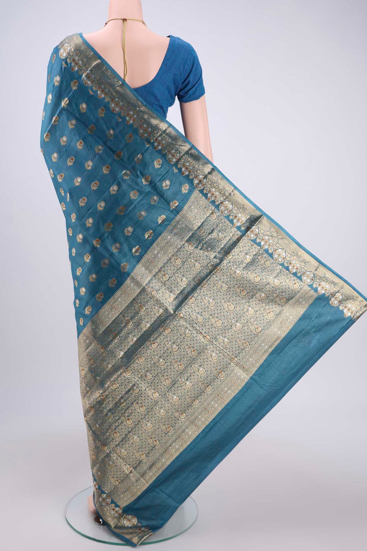 Flat view of Electric Blue Banarasi Tussar Silk Saree with Zari And Thread Butta on the body and Zari And Thread Border. 