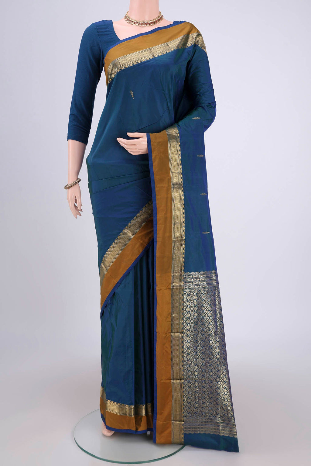 Peacock Blue Blended Bangalore Silk Saree with Zari Butta on the body and Zari Border.  displayed on a mannequin